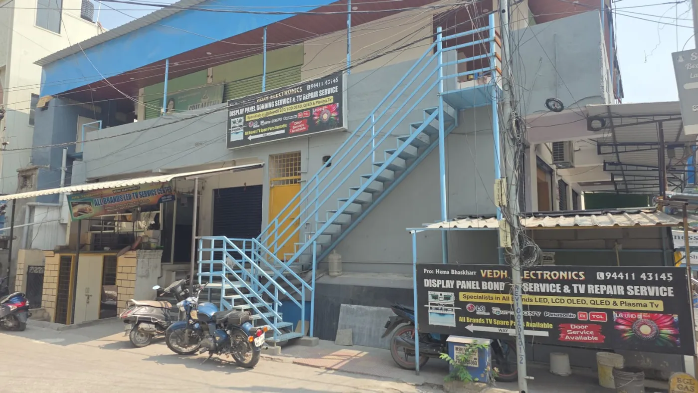 Building exterior and Vedh Electronics signs